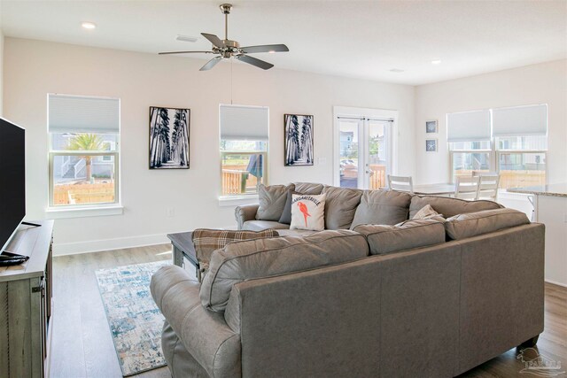 living room with ceiling fan, dark hardwood / wood-style floors, and french doors