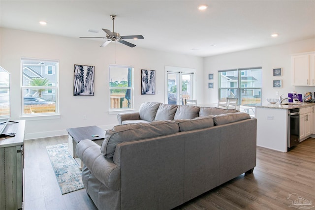 living room with ceiling fan and dark hardwood / wood-style floors