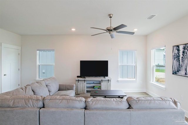 living room with ceiling fan and wood-type flooring