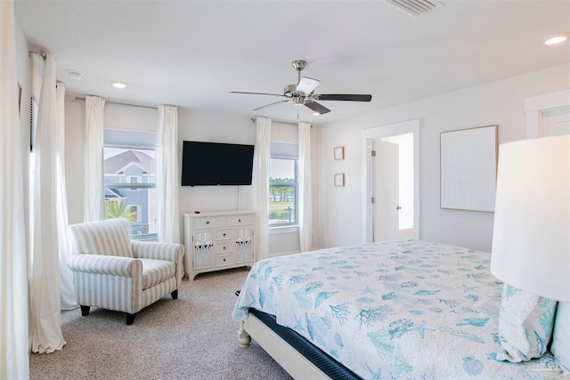 bedroom with ceiling fan and light colored carpet