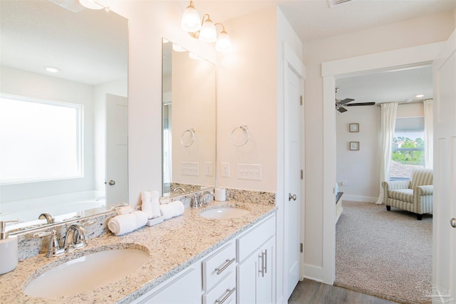 bathroom featuring wood-type flooring, ceiling fan, and vanity