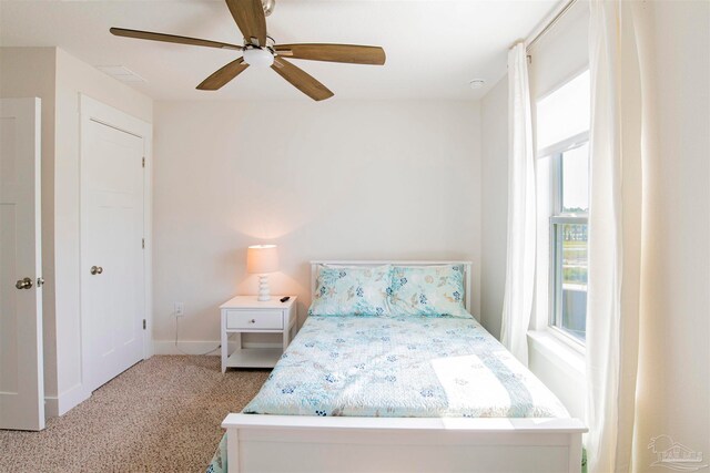 bedroom with light carpet and ceiling fan