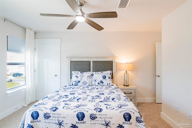 bedroom featuring ceiling fan and light carpet