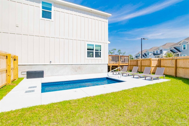 view of pool featuring a wooden deck and a yard