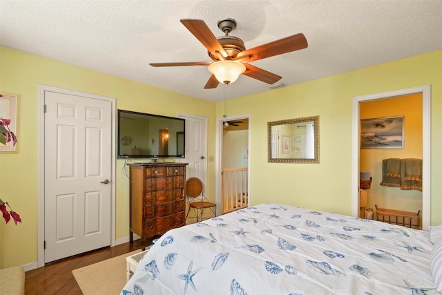 bedroom with a textured ceiling, hardwood / wood-style floors, and ceiling fan