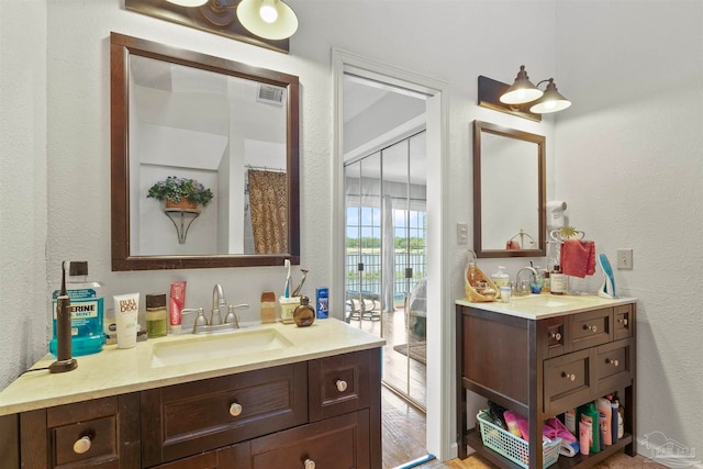 bathroom with hardwood / wood-style floors and double vanity