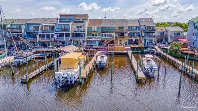 view of dock with a balcony and a water view