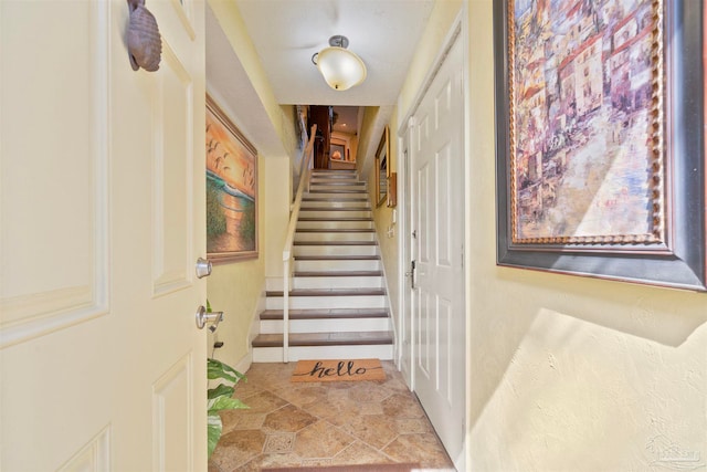 staircase featuring light tile patterned floors