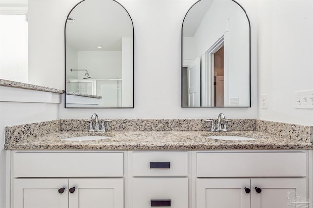 bathroom featuring walk in shower and vanity