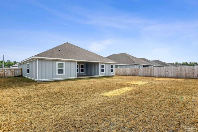 rear view of house with a lawn