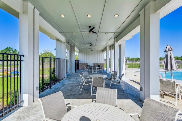 view of patio / terrace featuring a fenced in pool and ceiling fan