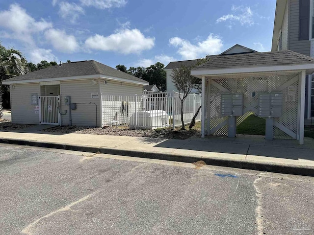 7101 Joy St Unit K7, Pensacola, FL 32504 - view of side of home featuring mail area and roof with shingles