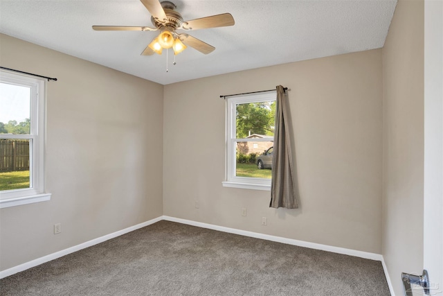 empty room with ceiling fan, baseboards, and carpet