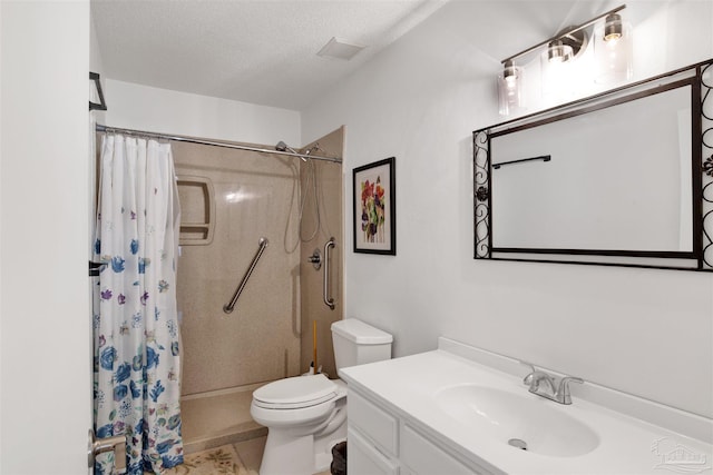 bathroom with vanity, curtained shower, a textured ceiling, and toilet