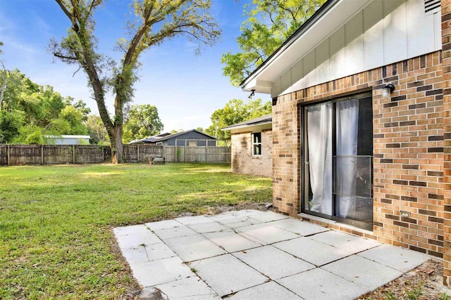 view of yard with a fenced backyard and a patio