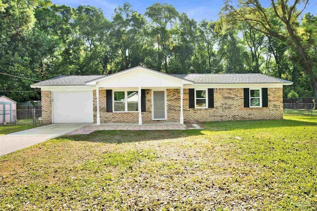 ranch-style house featuring a garage, a front yard, concrete driveway, and fence
