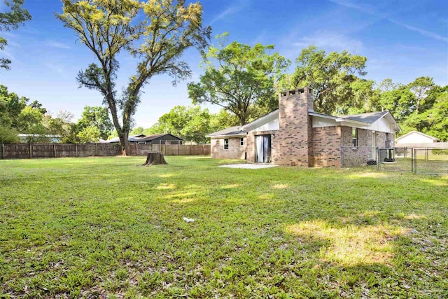 view of yard with a fenced backyard