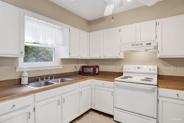 kitchen with white cabinets, white electric range, under cabinet range hood, dark countertops, and a sink