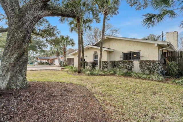 view of property exterior featuring a lawn