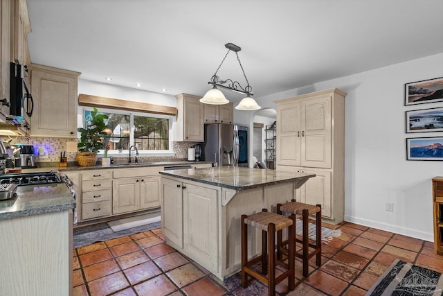 kitchen with stainless steel refrigerator with ice dispenser, a breakfast bar, a center island, and tasteful backsplash