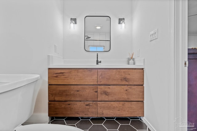 bathroom featuring vanity, tile patterned floors, and toilet