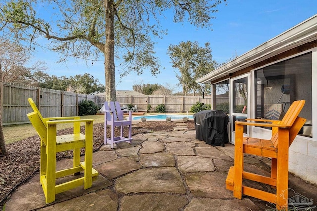 view of patio / terrace with area for grilling, a fenced in pool, and a sunroom