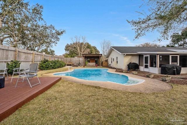 view of pool featuring a sunroom, a deck, and a lawn