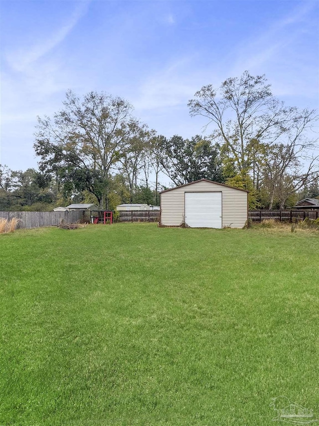 view of yard with a garage and an outdoor structure