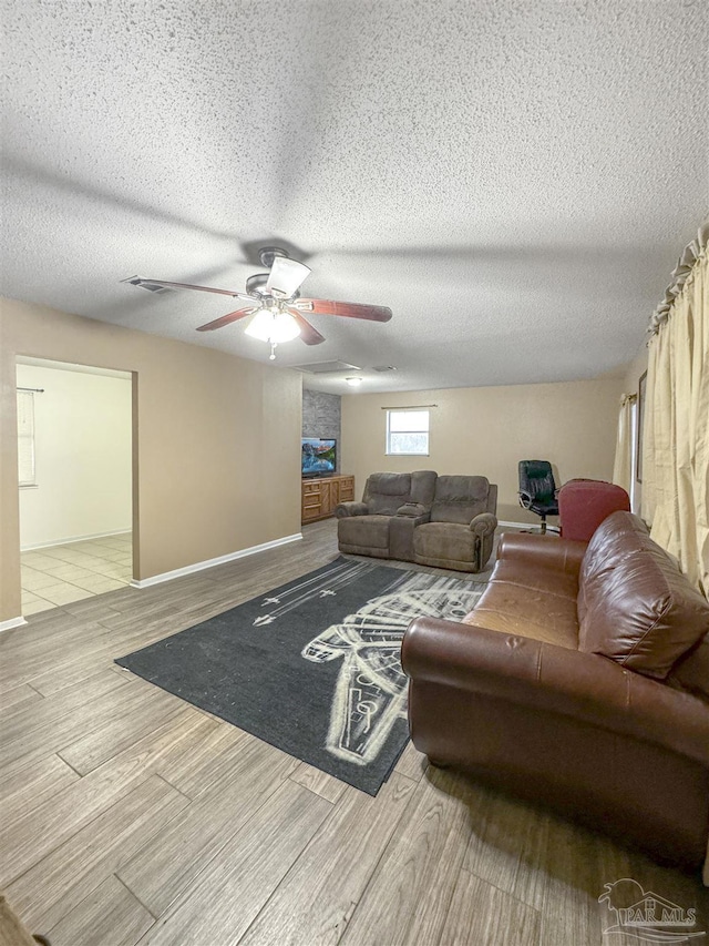 living room with ceiling fan and light hardwood / wood-style floors