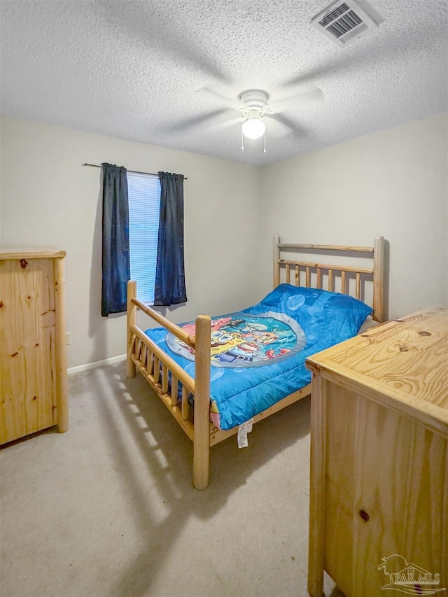 bedroom with a textured ceiling and ceiling fan