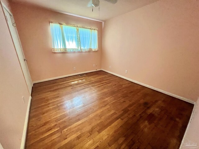 spare room with hardwood / wood-style flooring and ceiling fan