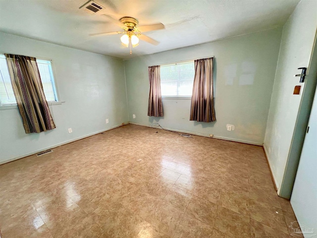 empty room with light tile patterned floors and ceiling fan