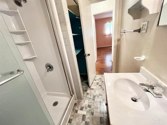 bathroom with vanity, hardwood / wood-style flooring, and an enclosed shower