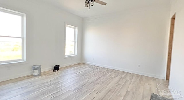 spare room with light wood-style floors, baseboards, and ceiling fan