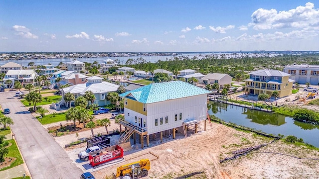 birds eye view of property featuring a residential view and a water view