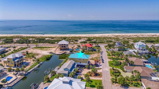 birds eye view of property featuring a beach view and a water view