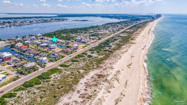 birds eye view of property featuring a water view and a beach view