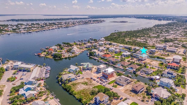 drone / aerial view with a residential view and a water view