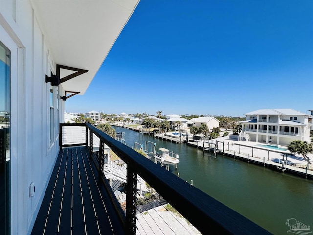 balcony with a residential view and a water view