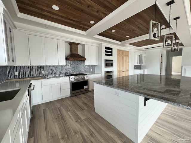 kitchen featuring a tray ceiling, stainless steel appliances, custom range hood, wood ceiling, and tasteful backsplash