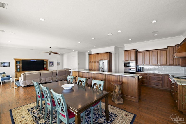 dining room with a ceiling fan, recessed lighting, dark wood-style flooring, and crown molding