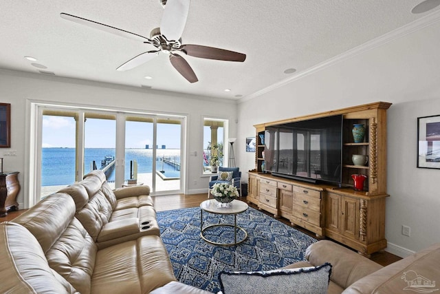 living area featuring a textured ceiling, crown molding, and wood finished floors