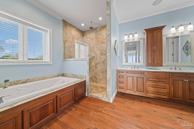 bathroom with vanity, hardwood / wood-style flooring, ornamental molding, shower with separate bathtub, and tile walls