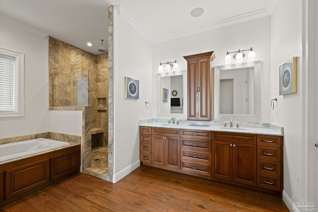 bathroom featuring crown molding, walk in shower, a sink, and wood finished floors