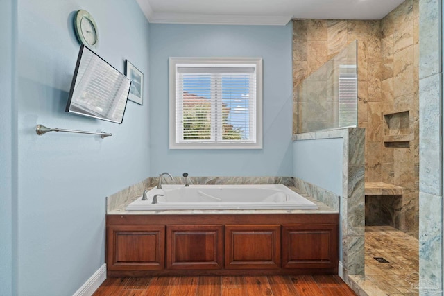 bathroom featuring ornamental molding, hardwood / wood-style flooring, and independent shower and bath