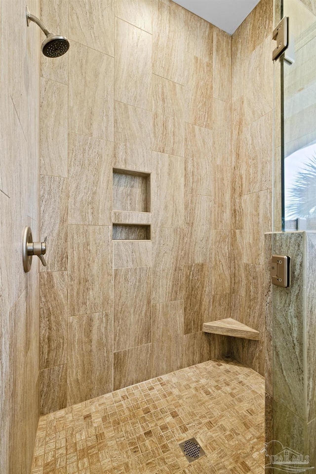 full bath with a tile shower