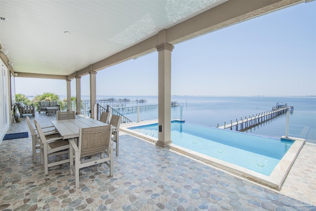 view of patio / terrace featuring outdoor dining space and a water view