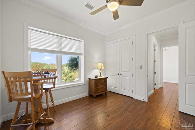 sitting room with ornamental molding, dark wood-type flooring, visible vents, and baseboards