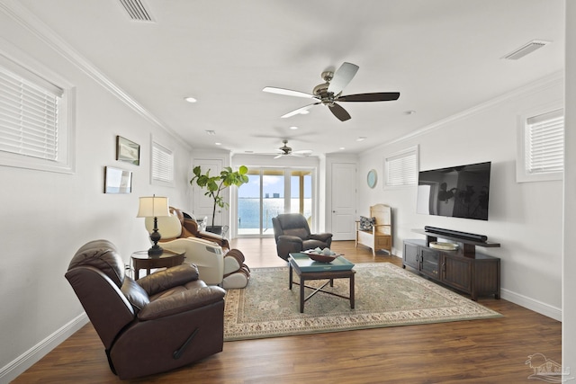 living room featuring ornamental molding, dark wood-type flooring, and baseboards