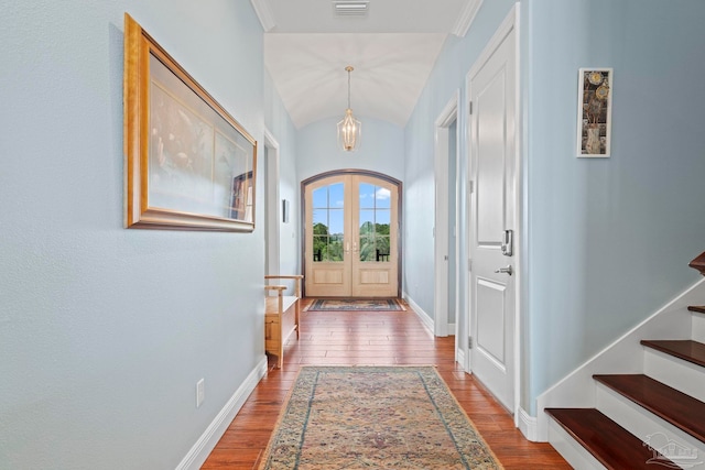 entryway with lofted ceiling, wood-type flooring, and french doors